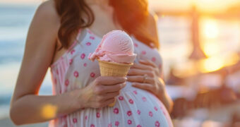 Schwangere Frau genießt ein Eis.